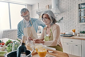 Active senior couple in aprons
