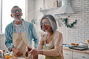 Active senior couple in aprons