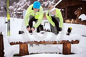 Senior couple getting ready for cross-country skiing.