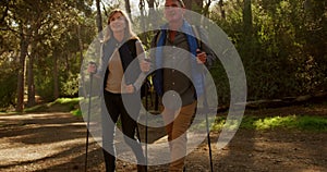 Active senior couple hiking in forest