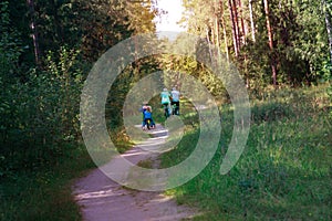 Active senior couple with kids riding bikes in nature