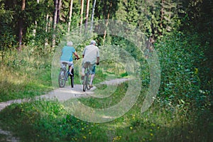 Active senior couple riding bikes in nature