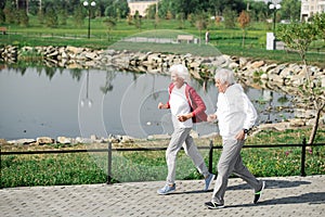 Active Senior Couple Running by Lake