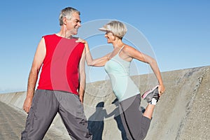 Active senior couple stretching before a jog