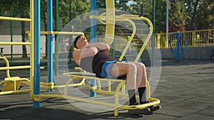 Active senior elderly old caucasian man do physical exercises in sport playground. Fitness leisure. Healthy lifestyle in