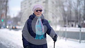 Active senior elderly woman training Nordic walking with trekking poles. Elderly woman practicing Nordic walking