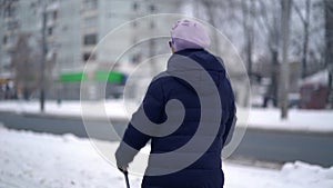 Active senior elderly woman training Nordic walking with trekking poles. Elderly woman practicing Nordic walking