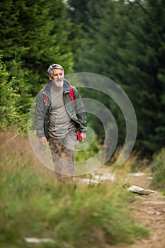 Active senior hiking in high mountains