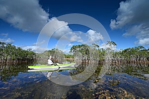 Active senior kayaking on Nine Mike Pond in Everglades National Park, Florida.