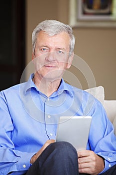Active senior man with tablet