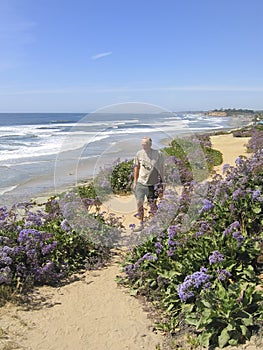 Active senior man walking along coastal path