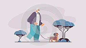 active senior man walking in park with his little dog grandfather relaxing with pet horizontal