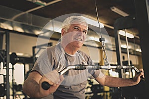 Active senior man working exercise in the gym.