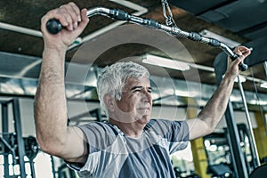 Active senior man working exercise in the gym. Man workout in gym.