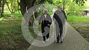 Active senior old couple. Man training Nordic walking, woman running in park