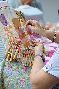 Active senior people workshop with traditional bobbin lace crochet. Hands detail and empty copy space