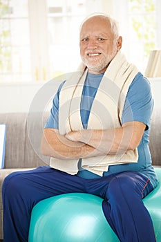 Active senior sitting on fit ball