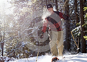 Active Senior on Snowshoes in Winter