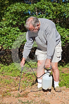 Active Senior Spraying Weeds