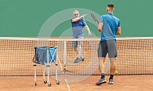Active senior at tennis training. Vitality, sports activity, healthy lifestyle in old age. Aging Youthfully concept photo