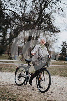 Active senior woman with bicycle enjoying a leisurely ride in the park