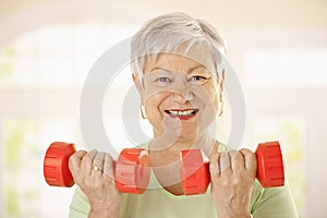 Active senior woman doing exercises photo