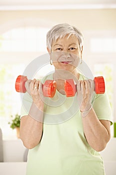 Active senior woman doing exercises