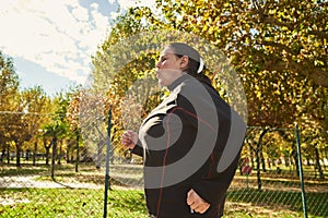 Active senior woman doing healthy exercises outdoors. Jogging