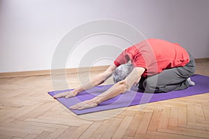 Active senior woman doing yoga