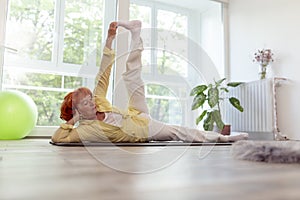 Active senior woman doing yoga