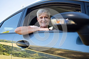 Active senior woman driving a car