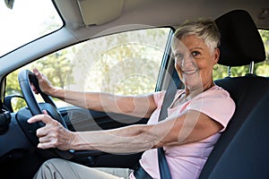 Active senior woman driving a car