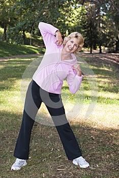 Active senior woman exercising in park