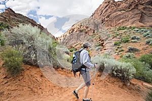 Active Senior Woman hiking in a beautiful red rock canyon