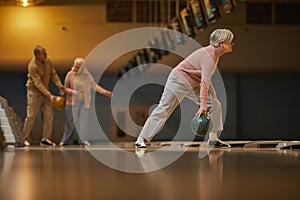 Active Senior Woman Playing Bowling Side View