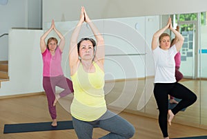Active senior woman practicing balancing yoga pose