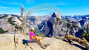 Active Senior Woman resting on a hike at Glacier Point in Yosemite National Park, California, United Sates