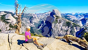 Active Senior Woman resting on a hike at Glacier Point in Yosemite National Park, California, United Sates