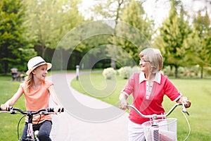 Active senior woman riding bike in a park