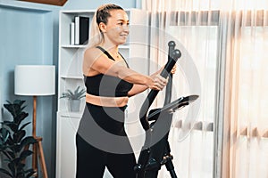 Active senior woman running on elliptical running machine. Clout