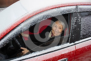 Active senior woman - smiling retired lady driving car