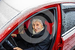 Active senior woman - smiling retired lady driving car