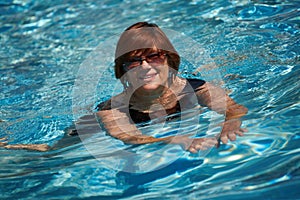 Active senior woman swimming