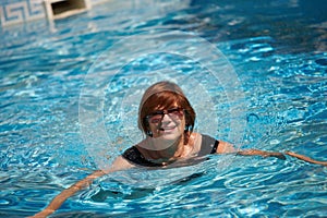 Active senior woman swimming