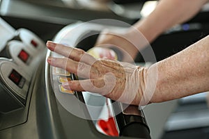 Active senior woman typing speed on exercise machine.