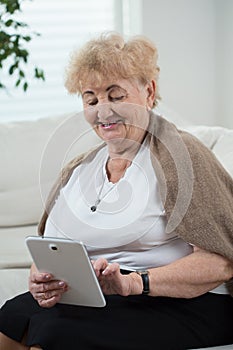 Active senior woman using tablet
