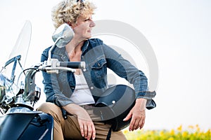Active senior woman wearing a blue denim jacket while sitting on