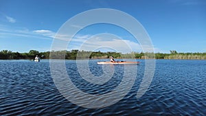 Active senior and young woman kayaking in Everglades National Park 4K.