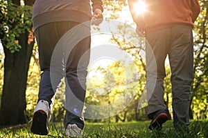 Active seniors exercising in forest. Only legs.