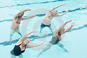 Active seniors exercising in swimming pool